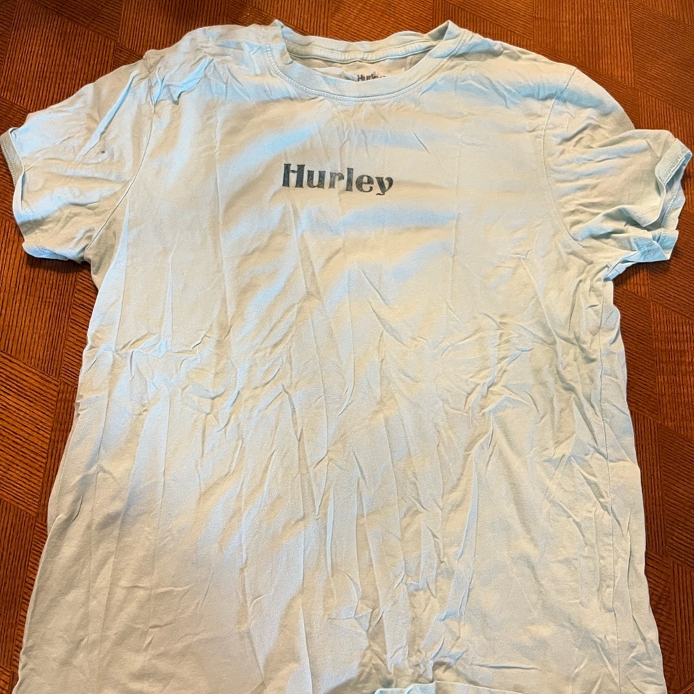 Light blue Hurley tee with design on back. Size medium